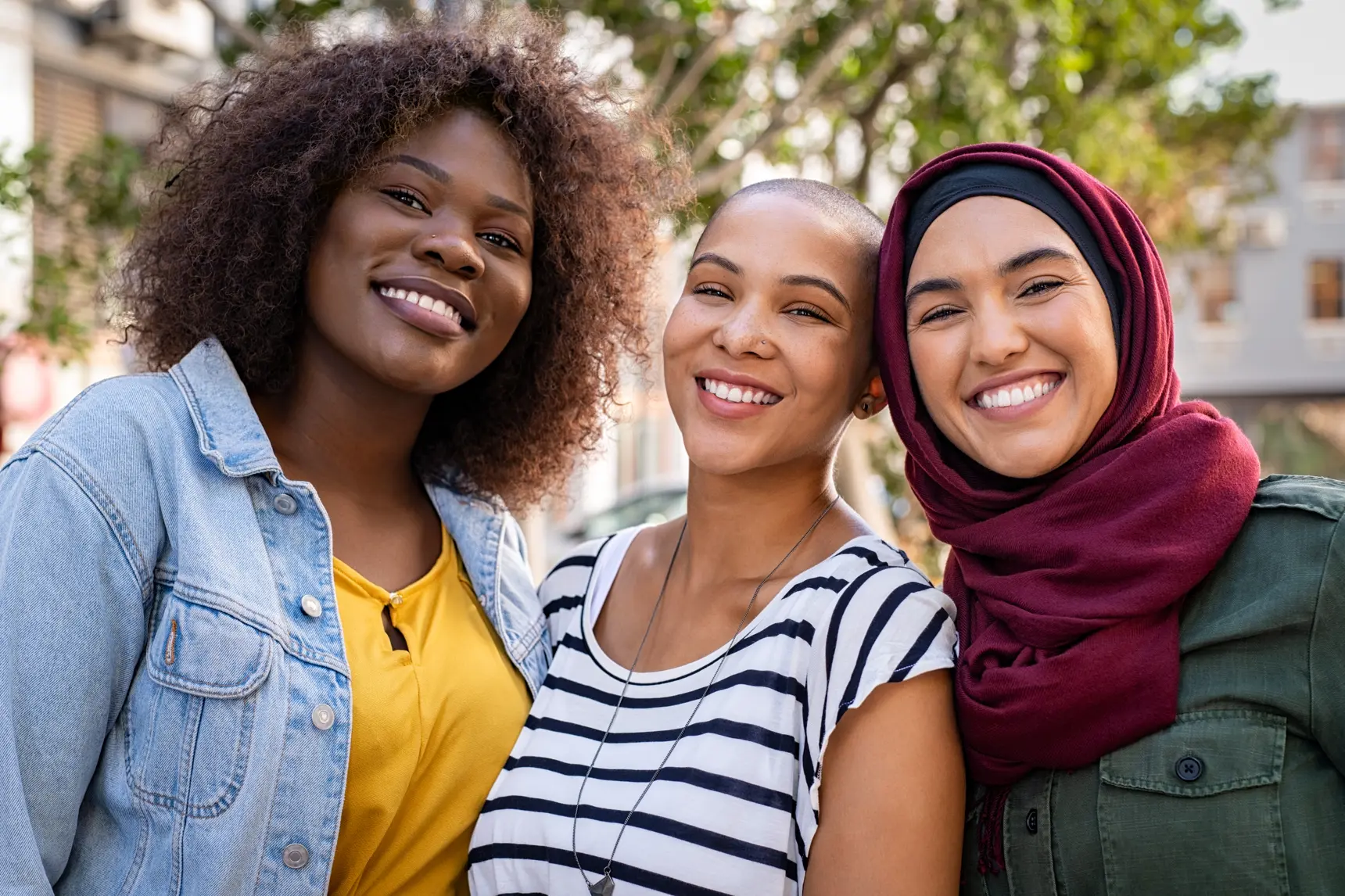 Three students smiling