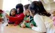 Kindergarten students using an iPad