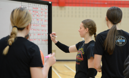 Volley ball players tracking information on a whiteboard