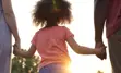 Parents holding a child's hand