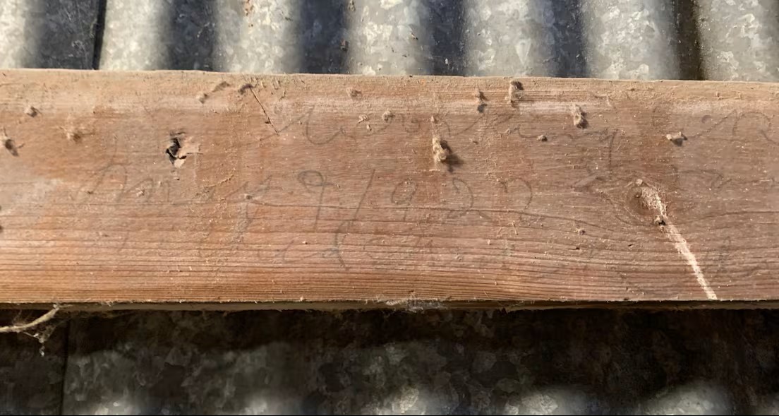 Engraving on a piece of wood in the barn on the site of the former Mount Elgin Industrial Institute. Photo Credit Michelle Both/CBC
